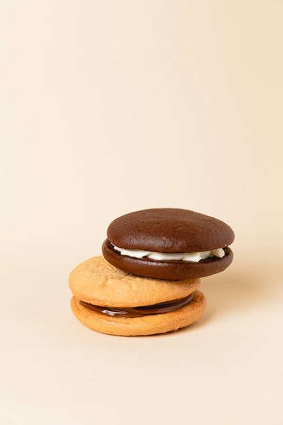 Close up Traditional chocolate and Pumpkin Whoopie pies. Background for bakeries, cafes, restaurants, copy space - Фото, изображение