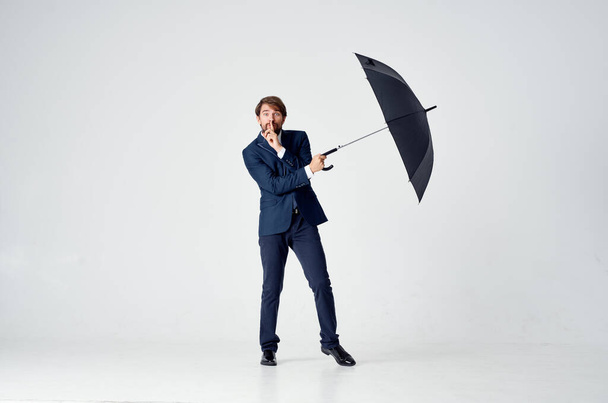 business man in a suit holding an umbrella  - Foto, afbeelding