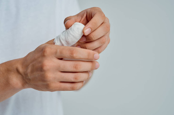 male patient in a white T-shirt with a bandaged hand hospital medicine - Photo, Image