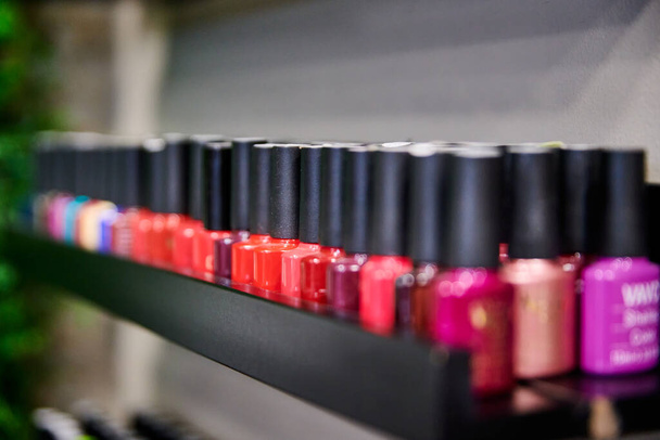 A closeup shot of colorful nail polish bottles captured in a manicure center - Fotoğraf, Görsel