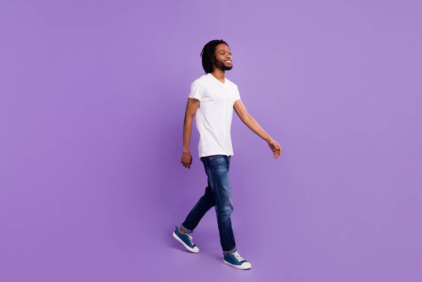 Full length body size view of attractive cheerful guy walking free time isolated over bright violet purple color background - Φωτογραφία, εικόνα