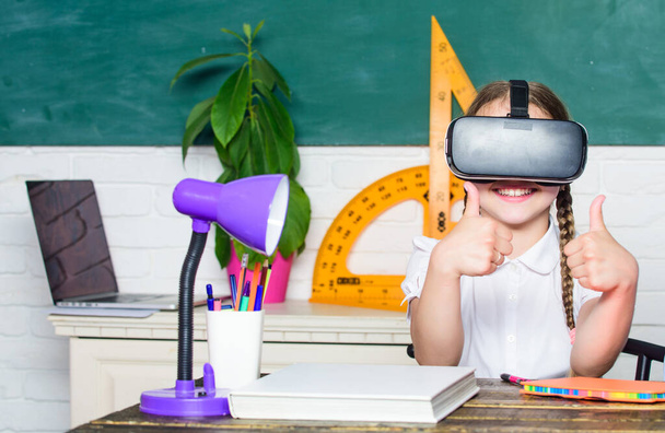 Studying in virtual reality. Modern technology. Interesting lesson. Homeschooling online. Girl kid study in virtual school. Virtual education. Child cute pupil wear hmd vr glasses. Virtual teaching - Photo, Image