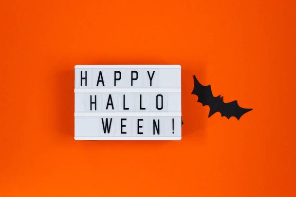 Halloween concept. Festive decorations. Bats on an orange background. - 写真・画像