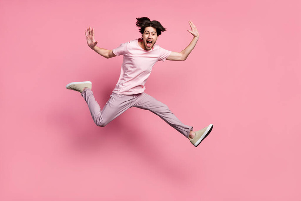 Full length body size man wearing casual clothes jumping up laughing isolated pastel pink color background - Foto, immagini