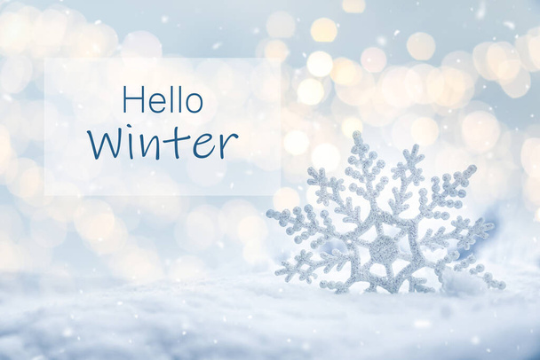 Hello Winter. Beautiful decorative snowflake in white snow, bokeh effect  - Fotó, kép