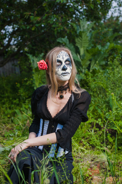 Gothic girl & thistle.Person in a carnival mask. Mexican death mask - Photo, Image