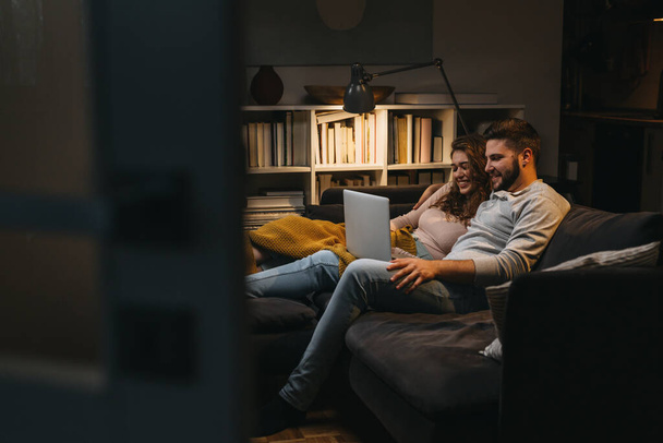 happy young couple enjoying time at home using laptop computer - Φωτογραφία, εικόνα