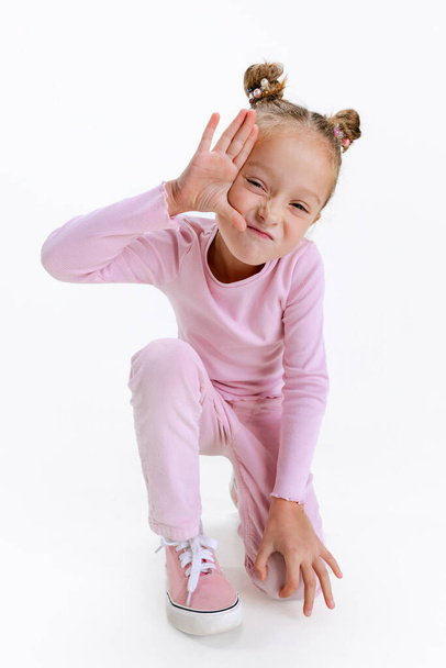 Funny cute little active Caucasian preschool girl posing isolated over white background. Happy childhood concept - Foto, afbeelding