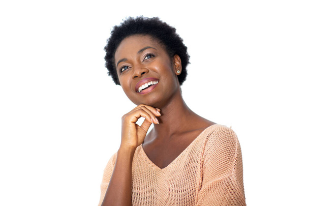 Close up portrait attractive young african American woman smiling with hands on chin by white background - Photo, Image