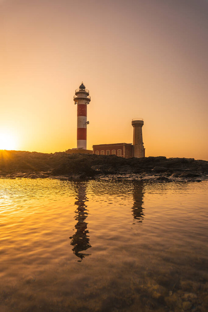Silhouette at Sunset of the Toston Lighthouse, Punta Ballena near the town of El Cotillo, Fuerteventura island, Canary Islands. Spain - Φωτογραφία, εικόνα