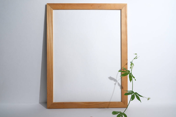 White paper in a light wooden frame. Mockup. - Foto, immagini