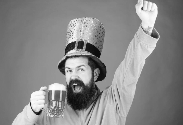 Drinking beer part celebration. Bar seasonal holiday menu. Green beer mug. Cheers. Alcohol beverage. Lets start patricks party. Irish tradition. Man brutal bearded hipster drink pint beer. Irish pub - Φωτογραφία, εικόνα