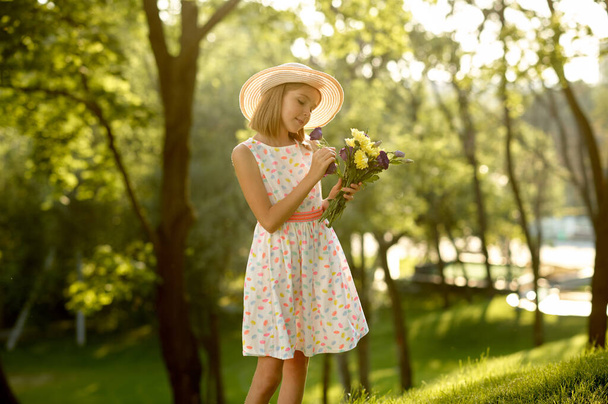 Childrens romantic date, little girl with bouquet - Photo, Image
