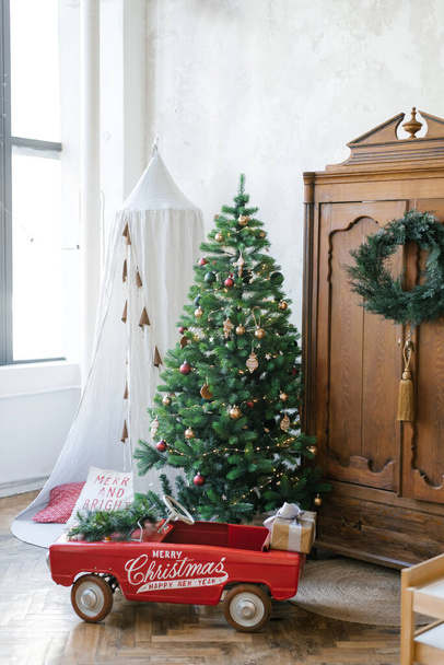 Christmas tree, wooden vintage cabinet, children's toy car, teepee or tent - Фото, зображення