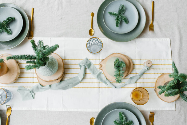 Winter Holiday Mood. Festive Christmas Table Setting in Green and Gold details. - Photo, Image