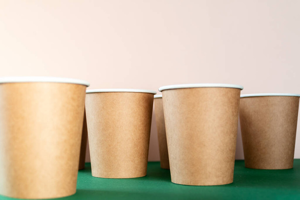 paper cup to go against green and pink background - Photo, image