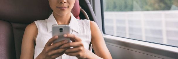 Bus travel commute young woman holding mobile phone texting using 5g technology device panoramic banner background. Businesspeople lifestyle. Closeup of hands on cellphone - Foto, afbeelding