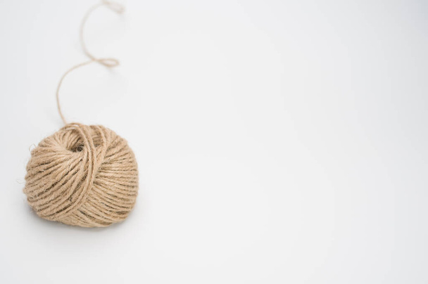 A closeup of a stationary yarn ball isolated on a white background - Fotó, kép