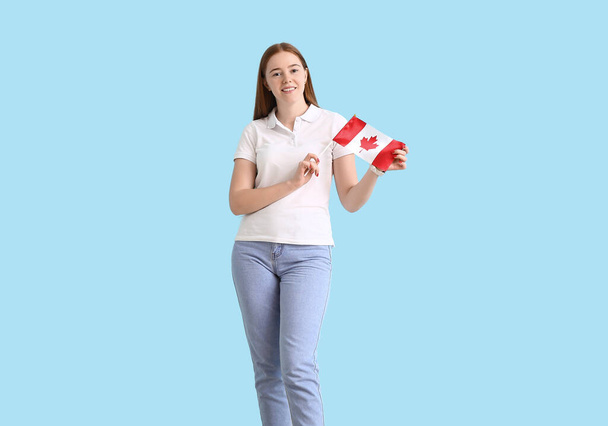Fiatal nő kanadai zászló színes háttér - Fotó, kép