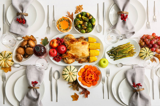 Table with roasted turkey and different food served for Thanksgiving dinner - Photo, Image