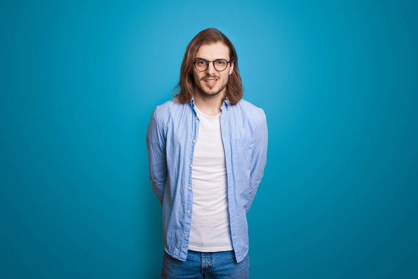 Man with long hair is handsome posing in stylish style. Fashion look. Beautiful male model. Fashion portrait. - Photo, Image