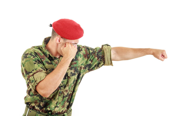 Soldier in military uniform and cap hitting with fist - Foto, Imagem