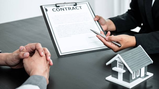 Sale Estate agent are presenting home loan to customer to decision signing contract to rental house insurance with approved property form. - Photo, Image