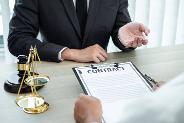 Male lawyer or counselor discussing negotiation legal case with client meeting with document contract in office, law and justice, attorney, lawsuit concept. - Photo, Image