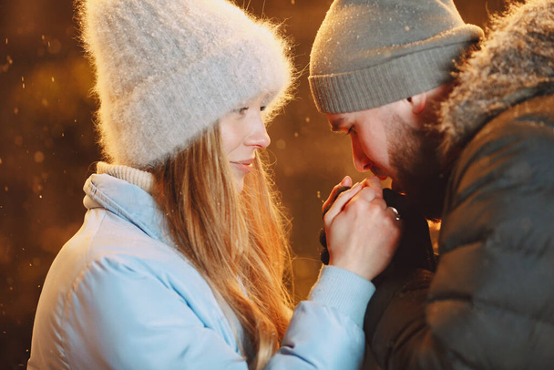 Young couple outdoor in night street at christmas time - Fotoğraf, Görsel