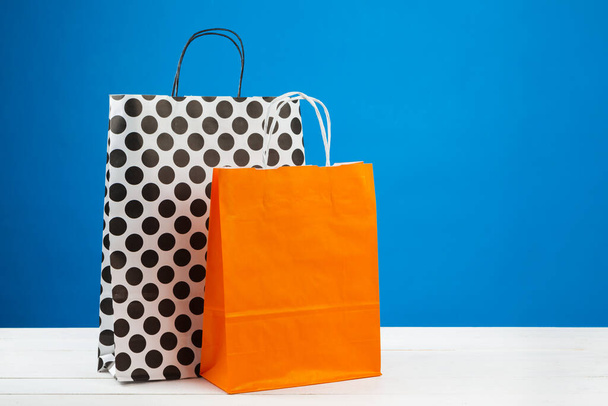 Arrangement of shopping bags on blue background - Photo, Image
