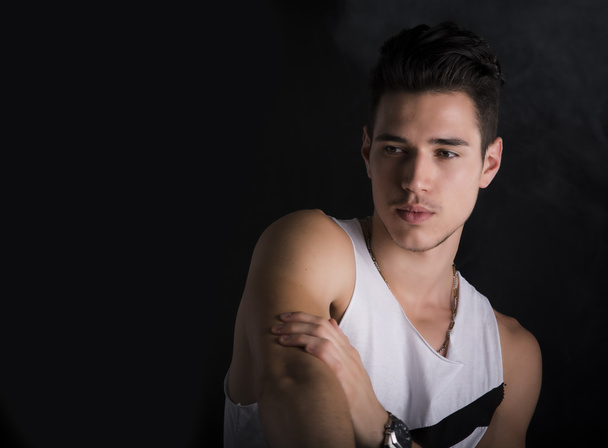 Handsome black haired young man on dark background - Foto, immagini
