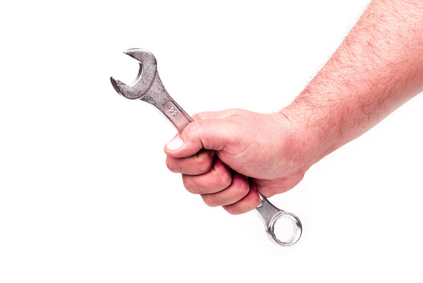 studio lighting. a human hand. wrench on a white background. - 写真・画像