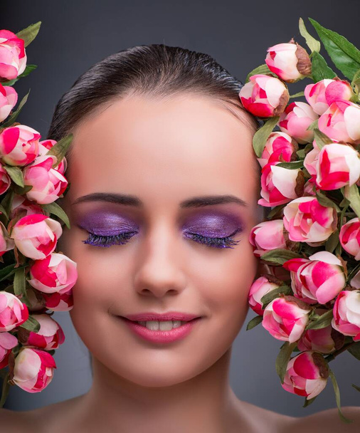 Young woman with flowers in beauty concept - Foto, Imagem