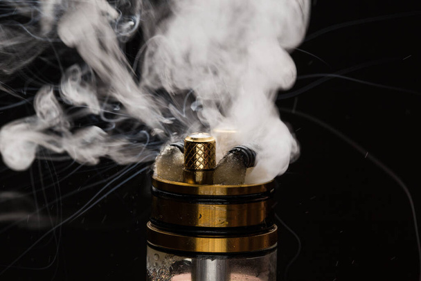 Vape close-up with smoke on a black background - Foto, Imagem