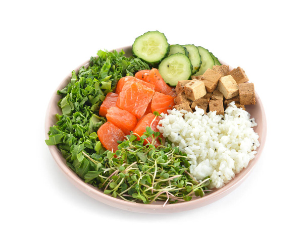 Tasty poke bowl with salmon, cucumber and tofu cheese on white background - Photo, Image