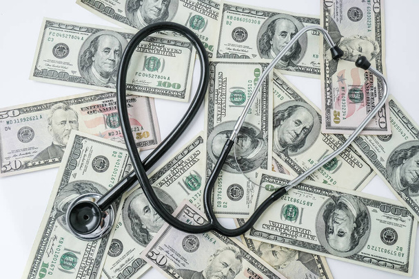 Stack of cash dollars and stethoscope. The concept of medical expensive medicine, doctors salary. Copy space for text. Health Life insurance. vaccination costs. Financial crisis. Covid-19 crimes - Zdjęcie, obraz