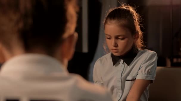 A beautiful young girl follows her opponent's chess moves - Footage, Video