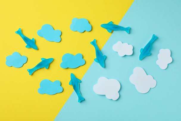 Gummy candies in the form of whale and decorative clouds on two tone background. - Photo, Image