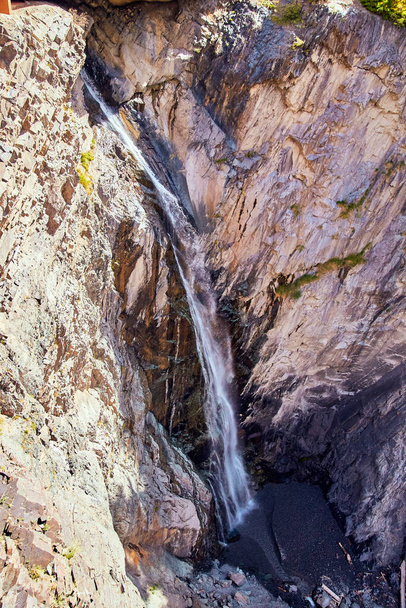 Vertical of waterfall cutting through gorge - Fotó, kép