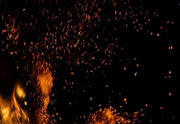 Flame of fire with sparks on a black background - Photo, Image