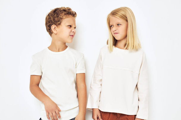 Bad brother sticks to sister little cheerful cheery friends isolated background - Photo, image