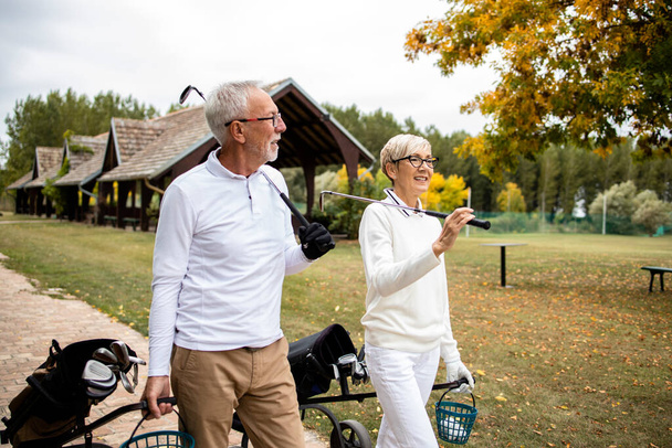 Пенсионеры отдыхают и играют в гольф. - Фото, изображение