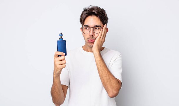 young hispanic man feeling bored, frustrated and sleepy after a tiresome. smoke vaporizer concept - Foto, immagini