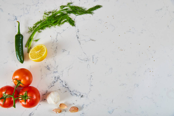 Fresh herbs and produce on white marble surface - Foto, immagini