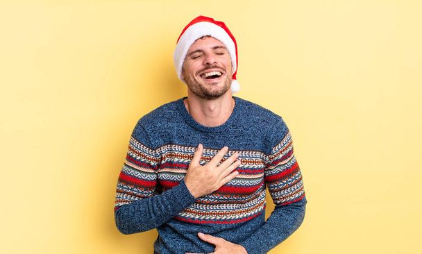 young handsome man laughing out loud at some hilarious joke. christmas concept - Foto, afbeelding