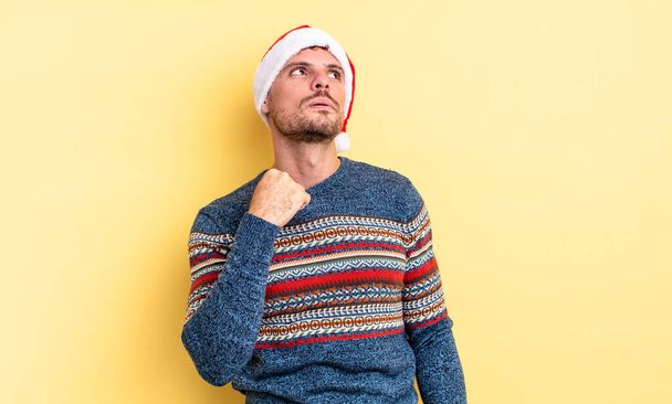 young handsome man feeling stressed, anxious, tired and frustrated. christmas concept - Foto, Bild