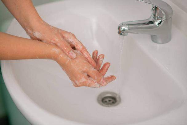 Крупным планом изображение женских рук, вымытых в водной раковине - Фото, изображение