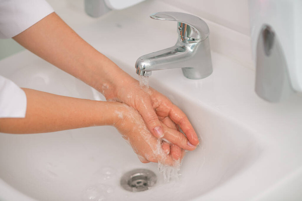 Bir su havzasında yıkanan kadın ellerini yakından çek. - Fotoğraf, Görsel