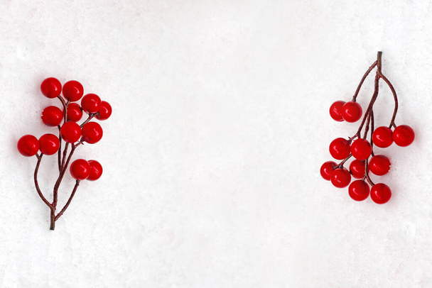 Red berries on a snowy background. Ideas for christmas time. - Photo, Image