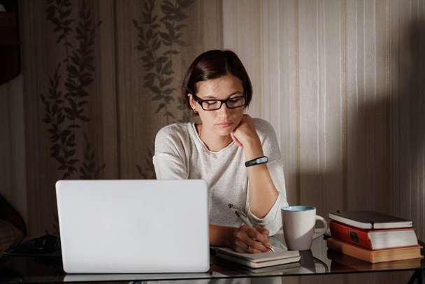 female student freelancer working at home on a task - Photo, Image